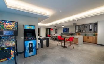 Game room with shuffleboard, ping pong, pinball and retro arcade games